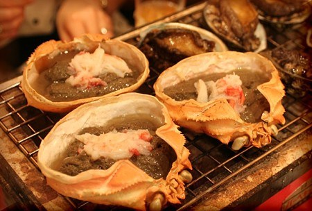 カニ味噌を網で焼いている