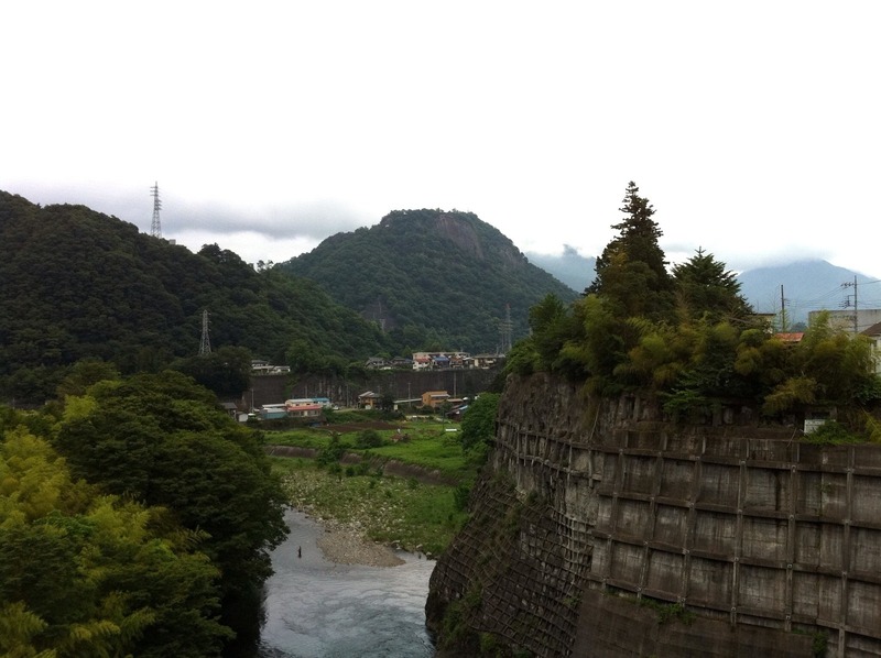 【岩殿城】岩殿城、遠景。中央の山が岩殿山。西側から撮影している。垂直の崖がすごい。中央の川は桂川。