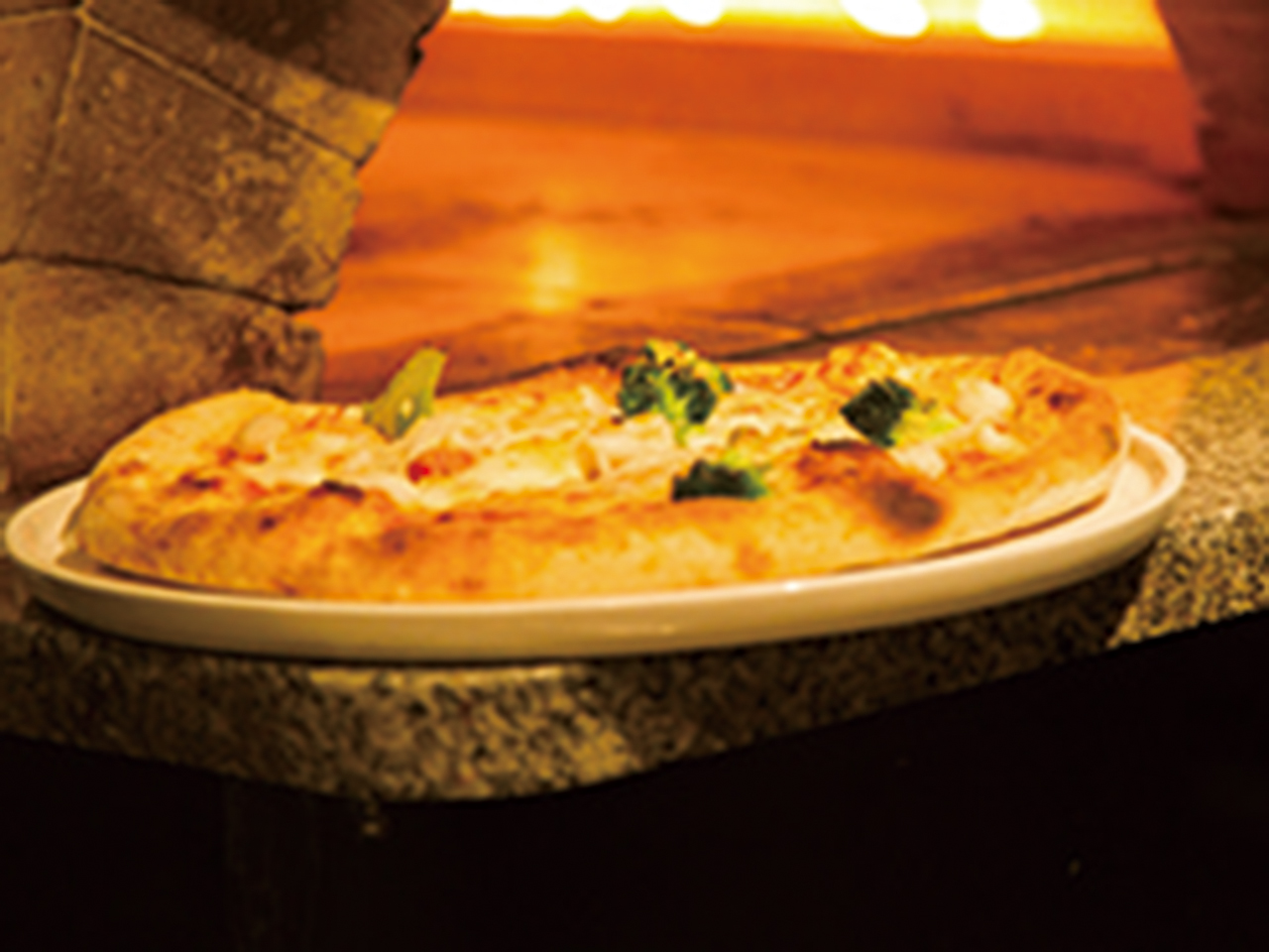 石窯で焼き上げる本格ピッツァのほか、パティシエが手作りする季節の味覚満載のドルチェも人気。