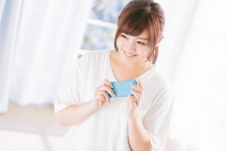 格安スマホに注目する女性
