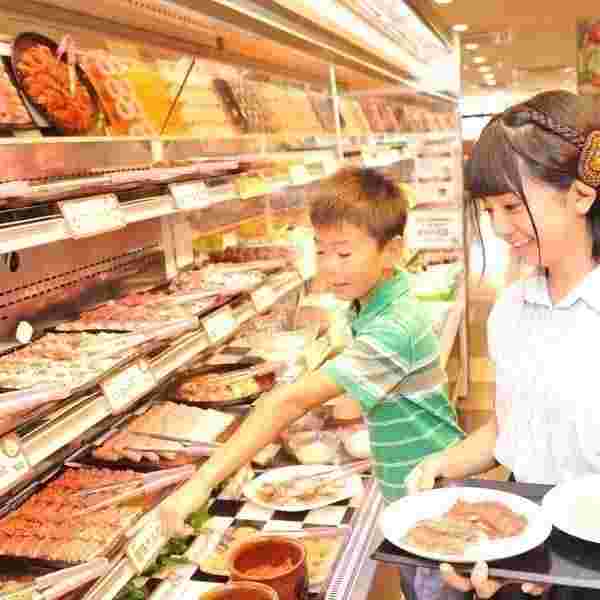 子供たちが食べ放題の料理を選んでいる