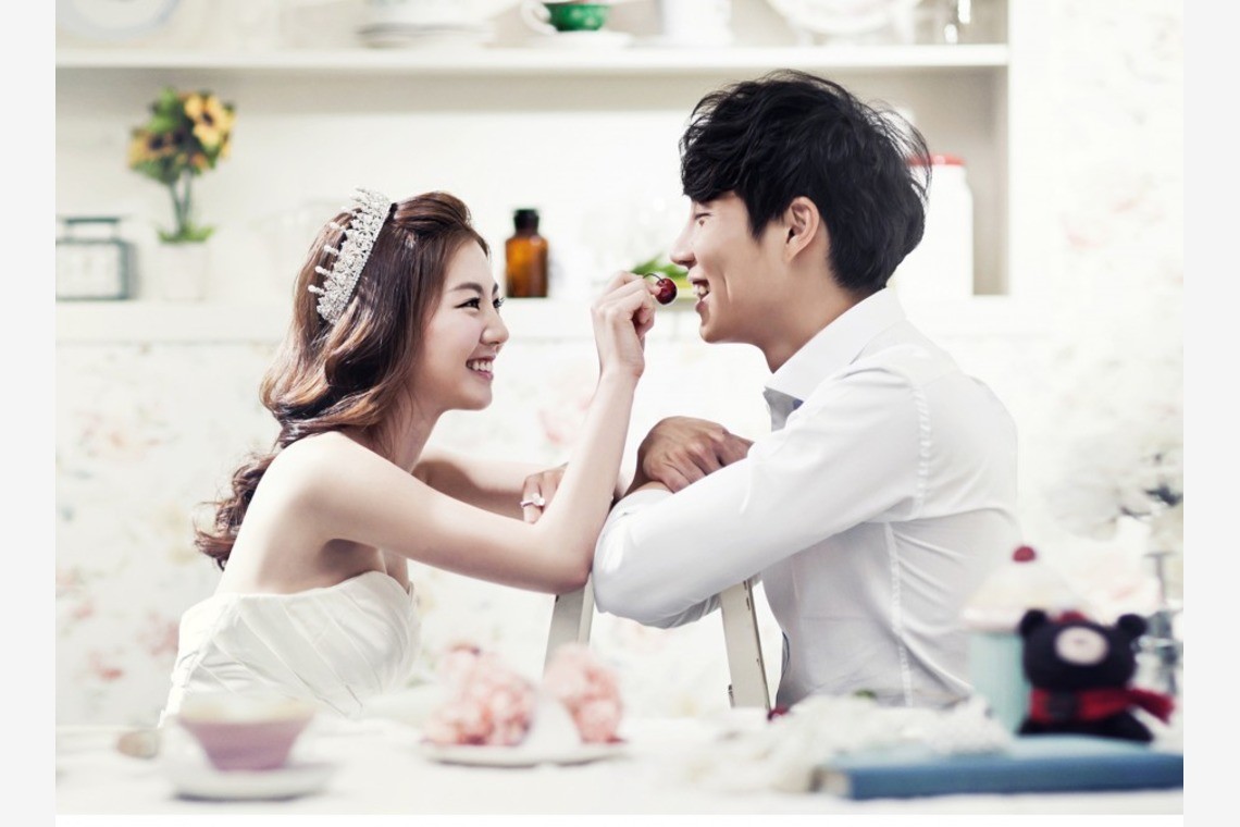 A couple taking a photo in a kitchen studio