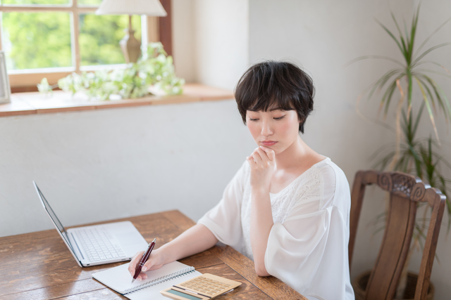 家計簿をつける女性