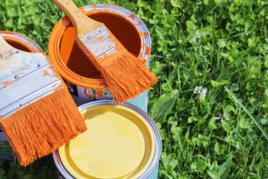 Paint cans, brushes, bright orange color