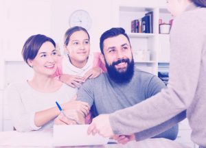 Parents signing property papers