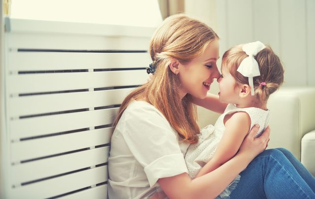Happy loving family. mother and child playing, kissing and hugging