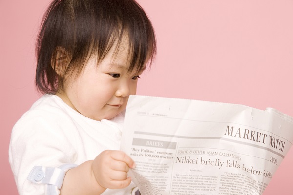 新聞紙を見る子ども