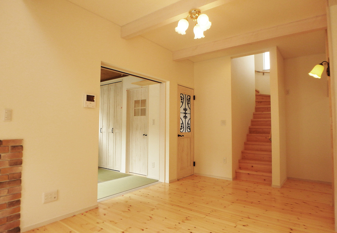 白を基調とした可愛らしい内装と無垢の床材が 家全体を優しく包む 奥はキッチンになっており 奥さんが笑顔で料理をする姿が思い浮かぶ イエタテ