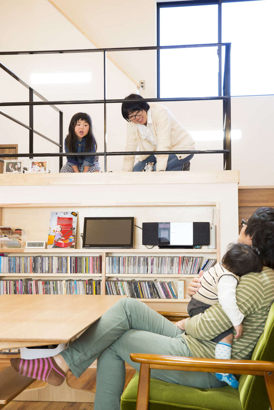 スキップフロアの上部は遊びのスペース 下部は子どもたちのおもちゃ収納に活用し 壁には夫婦が集めたcdがずらりと並ぶ 暮らし方や所有物に合わせ