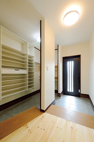玄関の上り框 かまち にはタモ無垢材の耳付板を使いオシャレにデザイン 二世帯のため シューズクロークにはたくさんのくつ棚を設置 壁は調湿性に