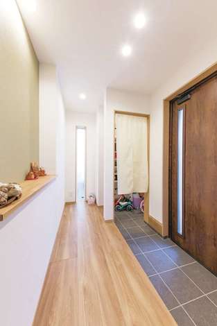 家族みんなでお出かけ準備ができるワイドスパンの玄関 奥行きのあるシューズクローゼットはご主人のサーフボードもすっぽり収納 正面の飾りニッチは