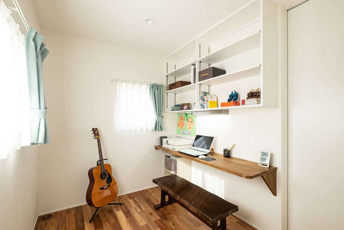 寝室には書斎を兼ねた趣味部屋を併設 アパートのときはなかなか出番がなかったギターもインテリアの主役に ご主人が憧れていたという ギターを弾