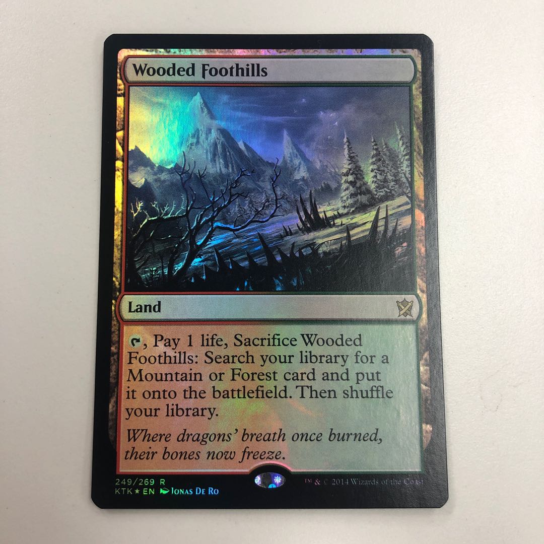 樹木茂る山麓 foil 英語版