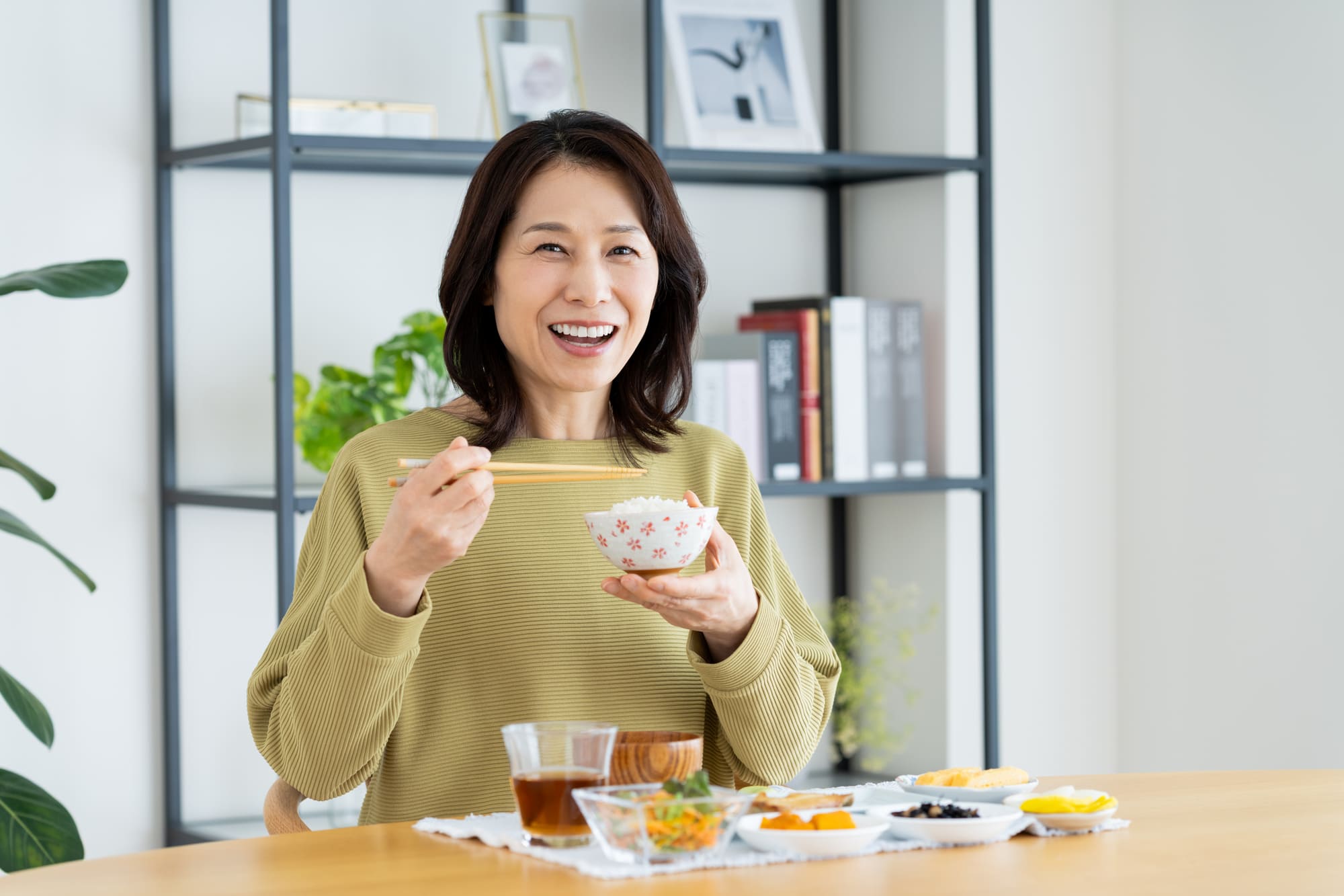 自宅で食事をしている笑顔の女性