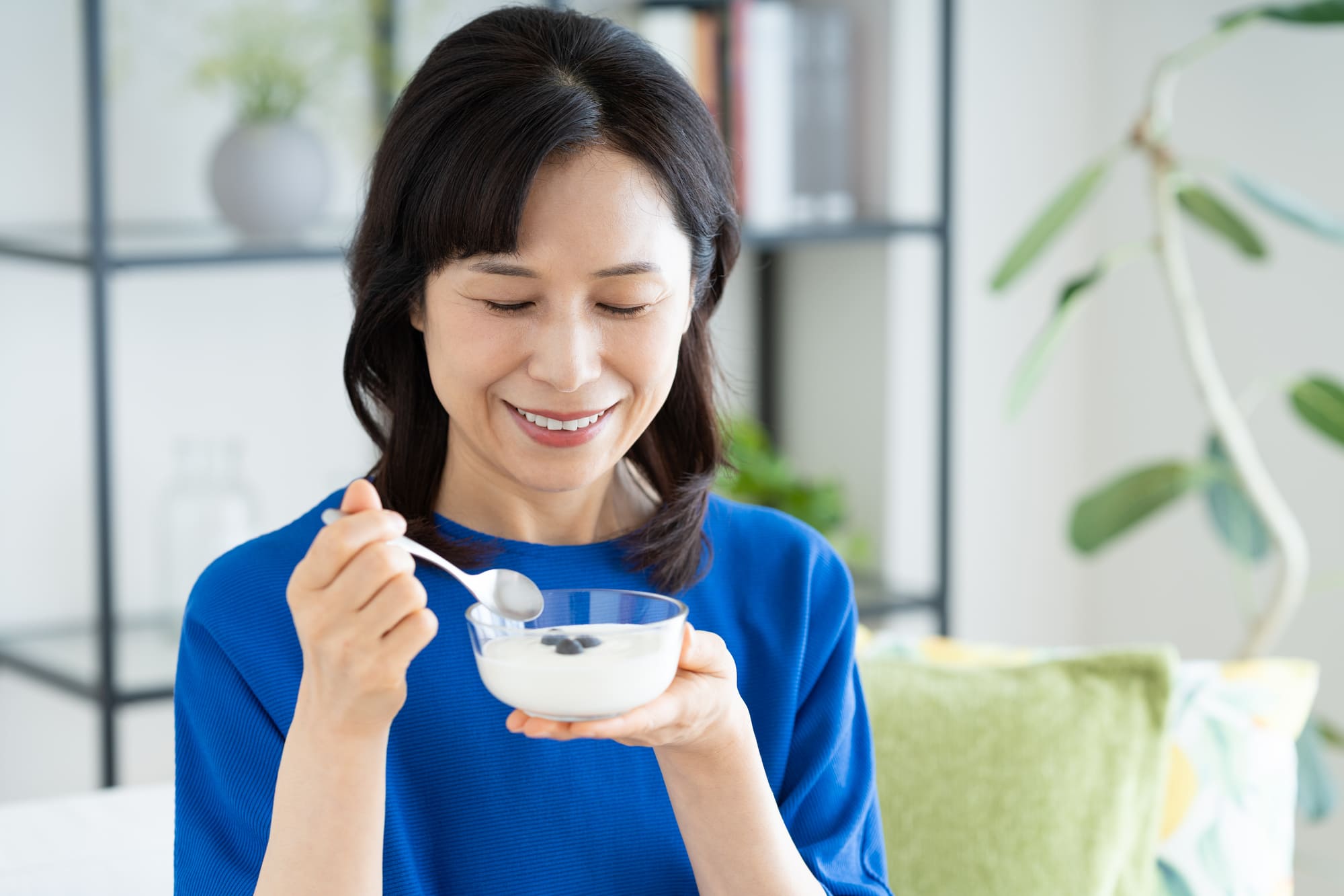 ヨーグルトを食べている女性