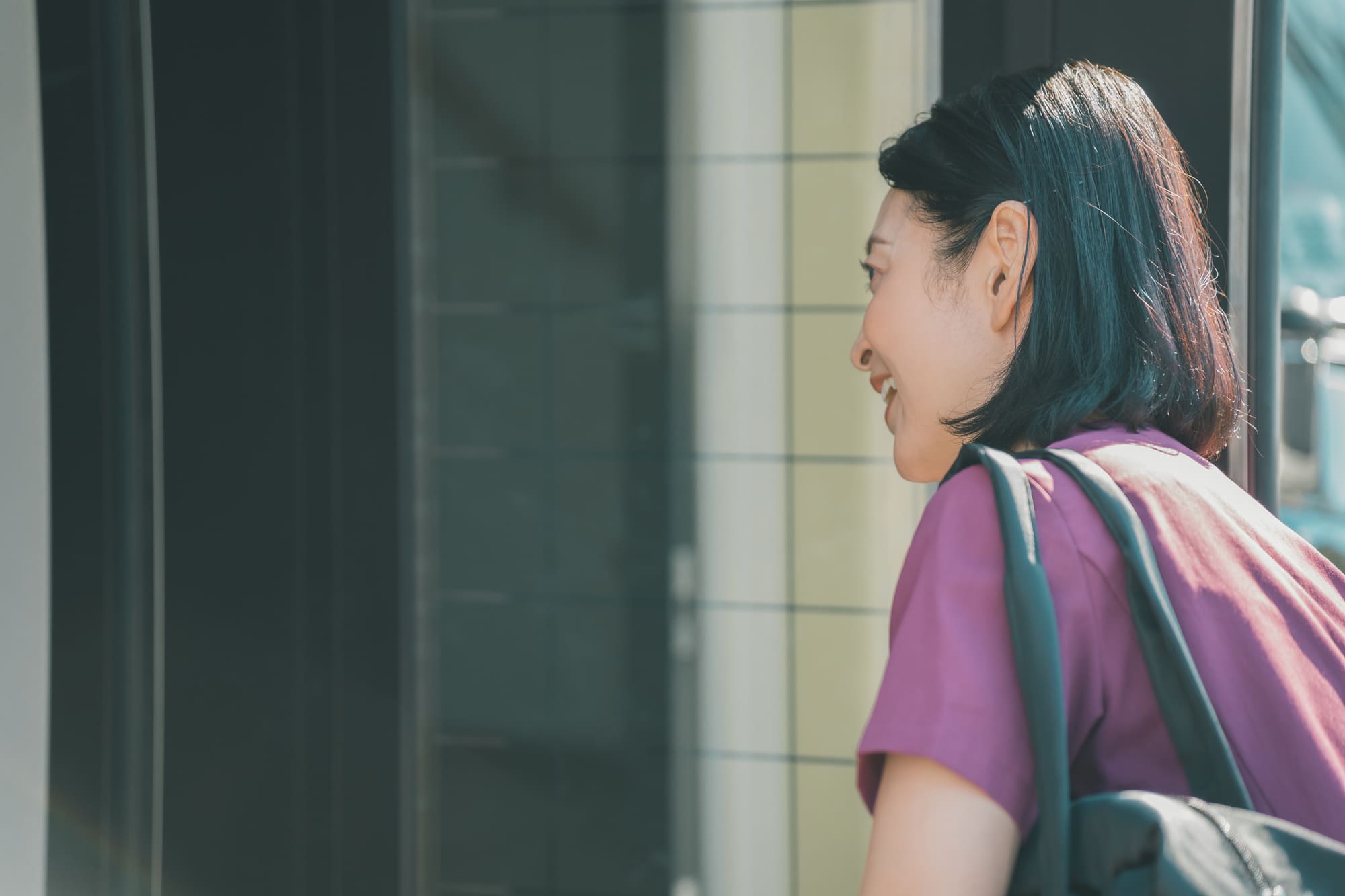 玄関先で家の中に声をかける女性