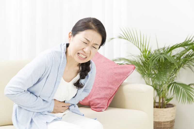 お腹あたりを痛がっている人