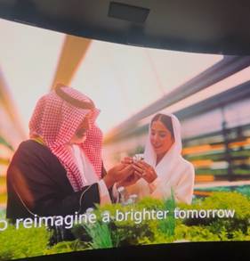 A person and person in white robes
Description automatically generated