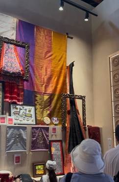 A group of people looking at a picture
Description automatically generated