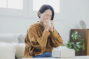 鼻をかむ女性の写真