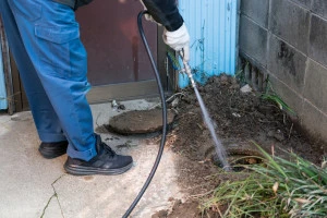 排水管の高圧洗浄を行っている作業員の写真