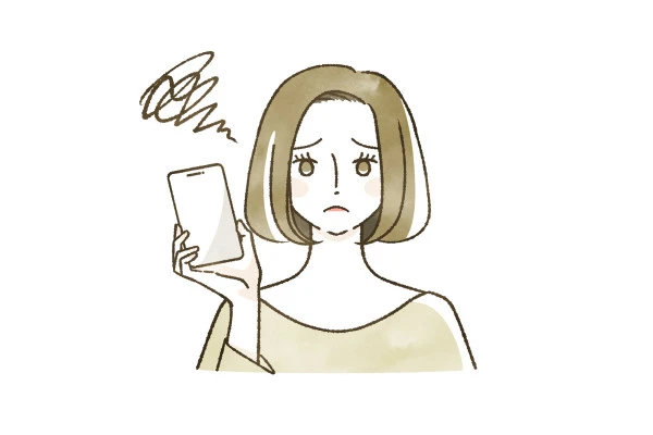 スマホを持って悩んでいる女性