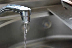 キッチンの蛇口の水抜きを行っている様子