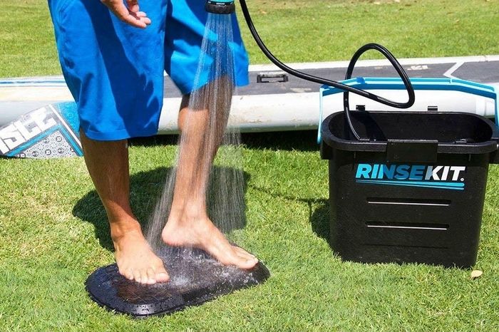 簡易シャワーで足を流す男性