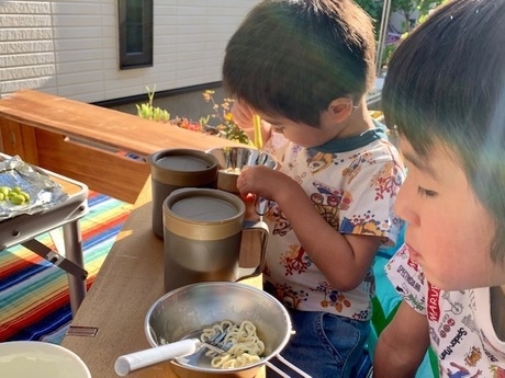 燻製ラーメンを食べる子供