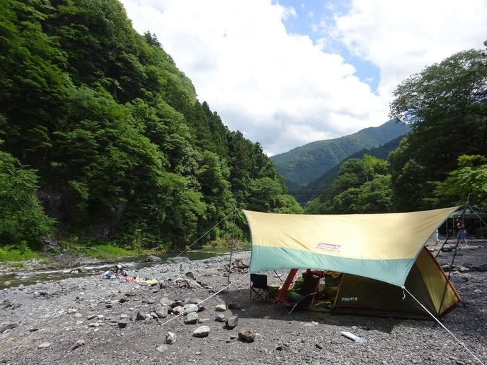 コールマンのタープを張ってキャンプをしている画像