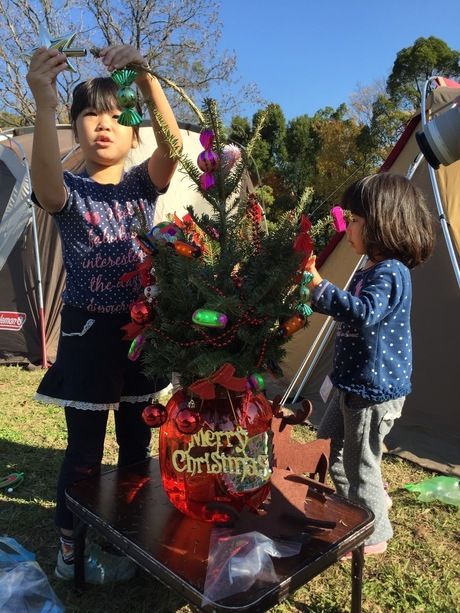 クリスマスツリーに飾りをする子供