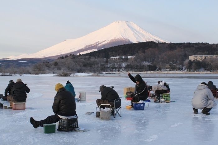 富士山のしたでワカサギ釣りをする人々