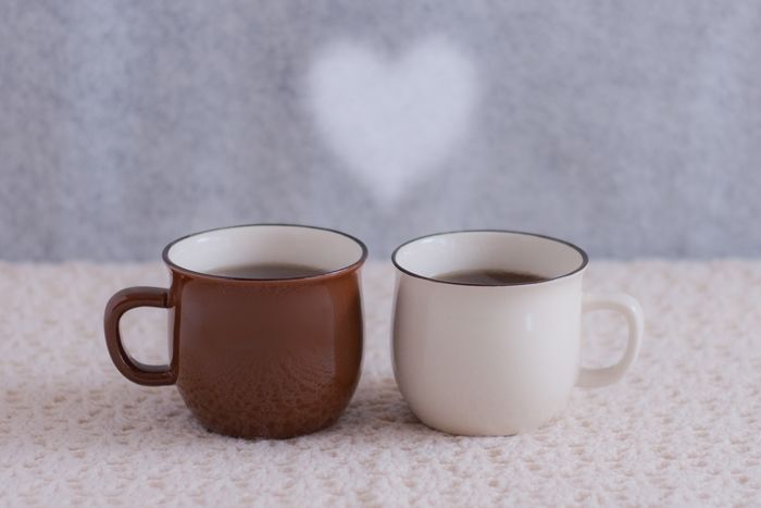 茶色と白色のマグカップに入れたコーヒー