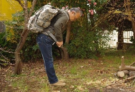 バックパックのウエストベルトをしめる男性