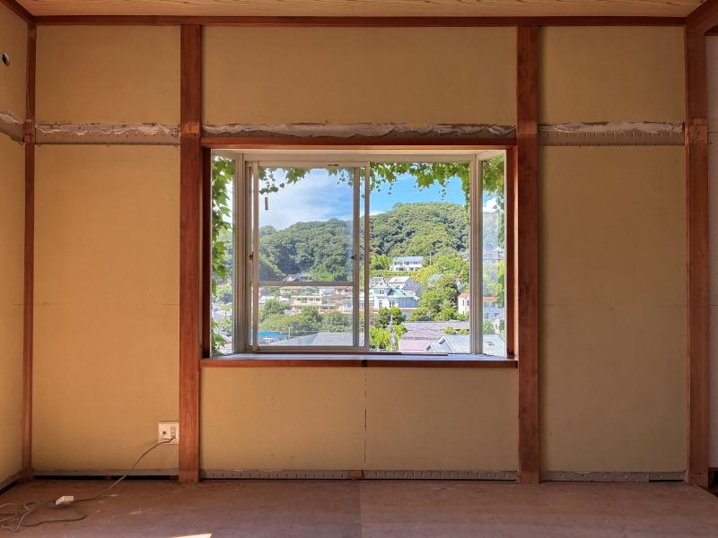 葉山町堀内の売買物件/和室1｜窓枠で切り取られる葉山の空と山並み。畳は撤去されています。