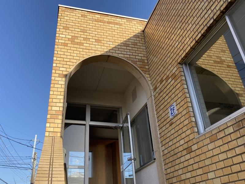 横浜市金沢区寺前一丁目の賃貸物件/玄関前のアーチの壁│2Fと青字で記されたプレートがかわいい