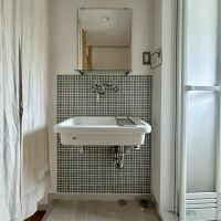 神戸市須磨区高倉台の売買物件/洗面所はシンプルな露出配管のシンクとタイル