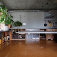 京都市左京区北白川追分町1-4の売買物件/畳のリビングからみるダイニング。床材はコルク。カウンター下は収納になっている（photo by来田猛氏）