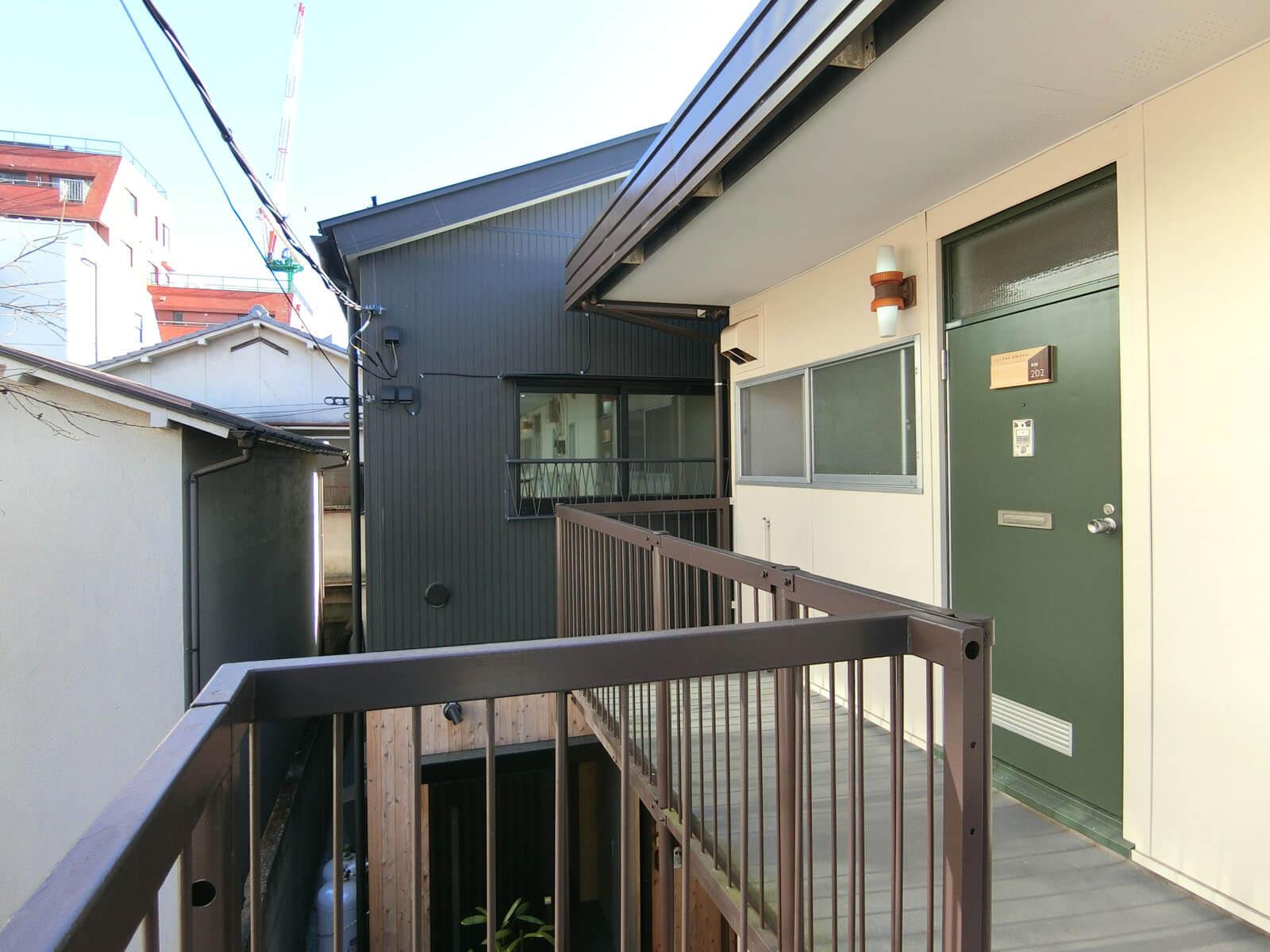 八王子市天神町の賃貸物件/グリーンの扉がかわいい玄関、黒壁の母屋はすぐとなりです