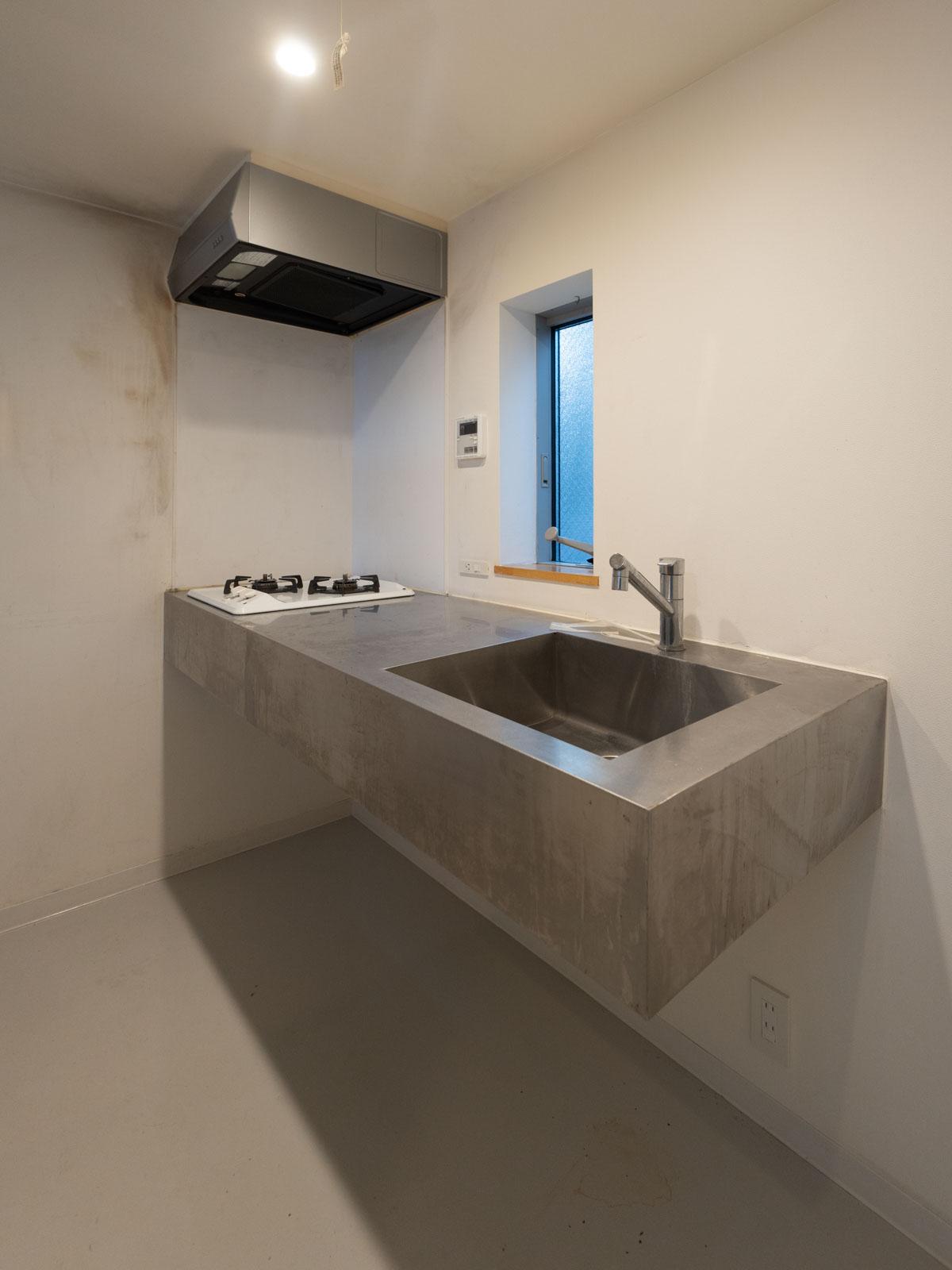 大田区東六郷の賃貸物件/中3階：ミニマルなデザインのステンレスキッチン。ガスコンロは2口