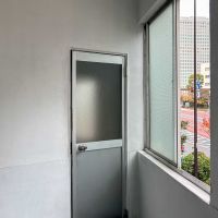 江東区永代の賃貸物件/2階：階段室の扉は、昔ながらのアルミドア