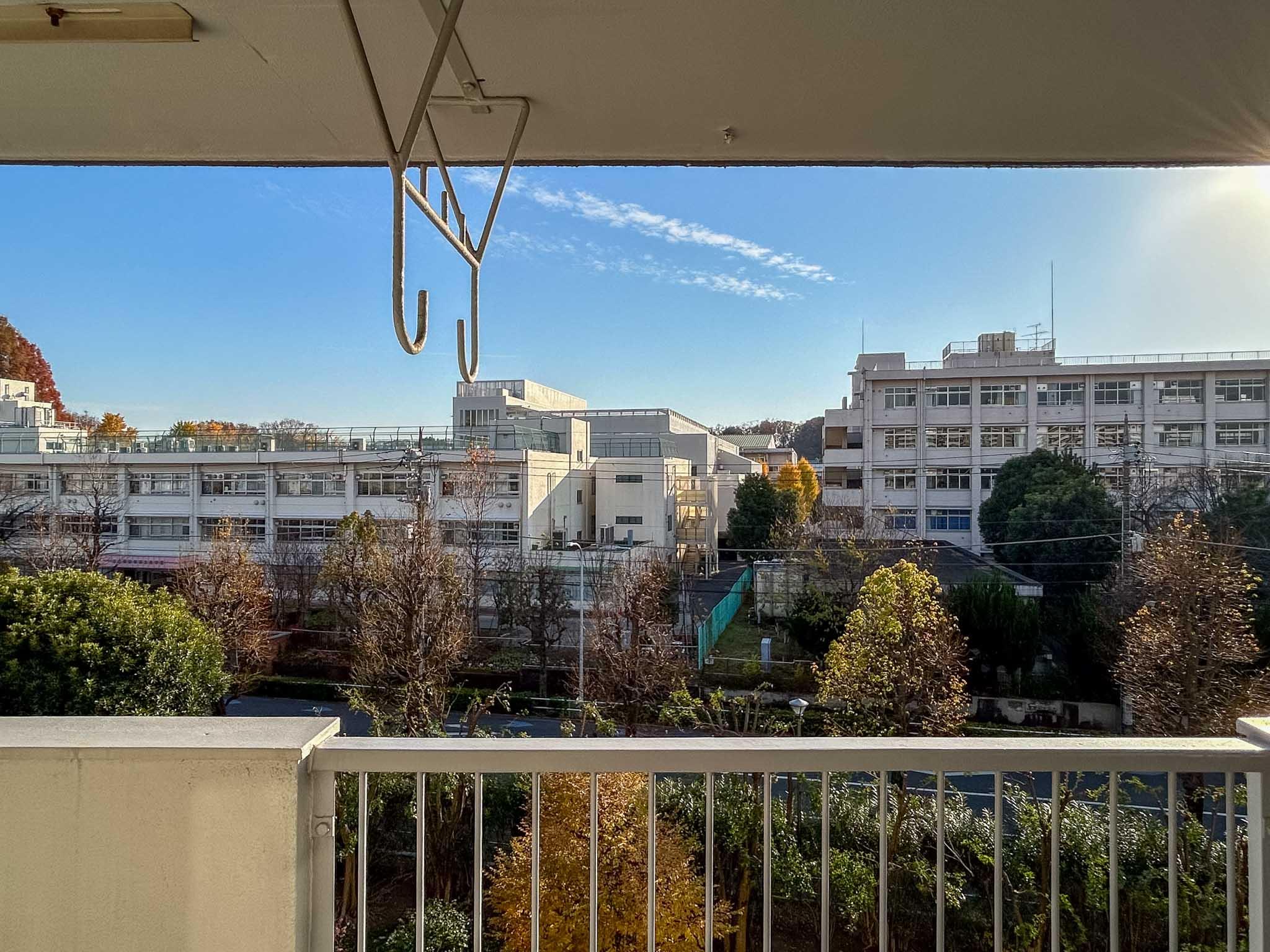 板橋区高島平の賃貸物件/目の前に広がる敷地内の緑。道路を挟んだ先にあるのは高校