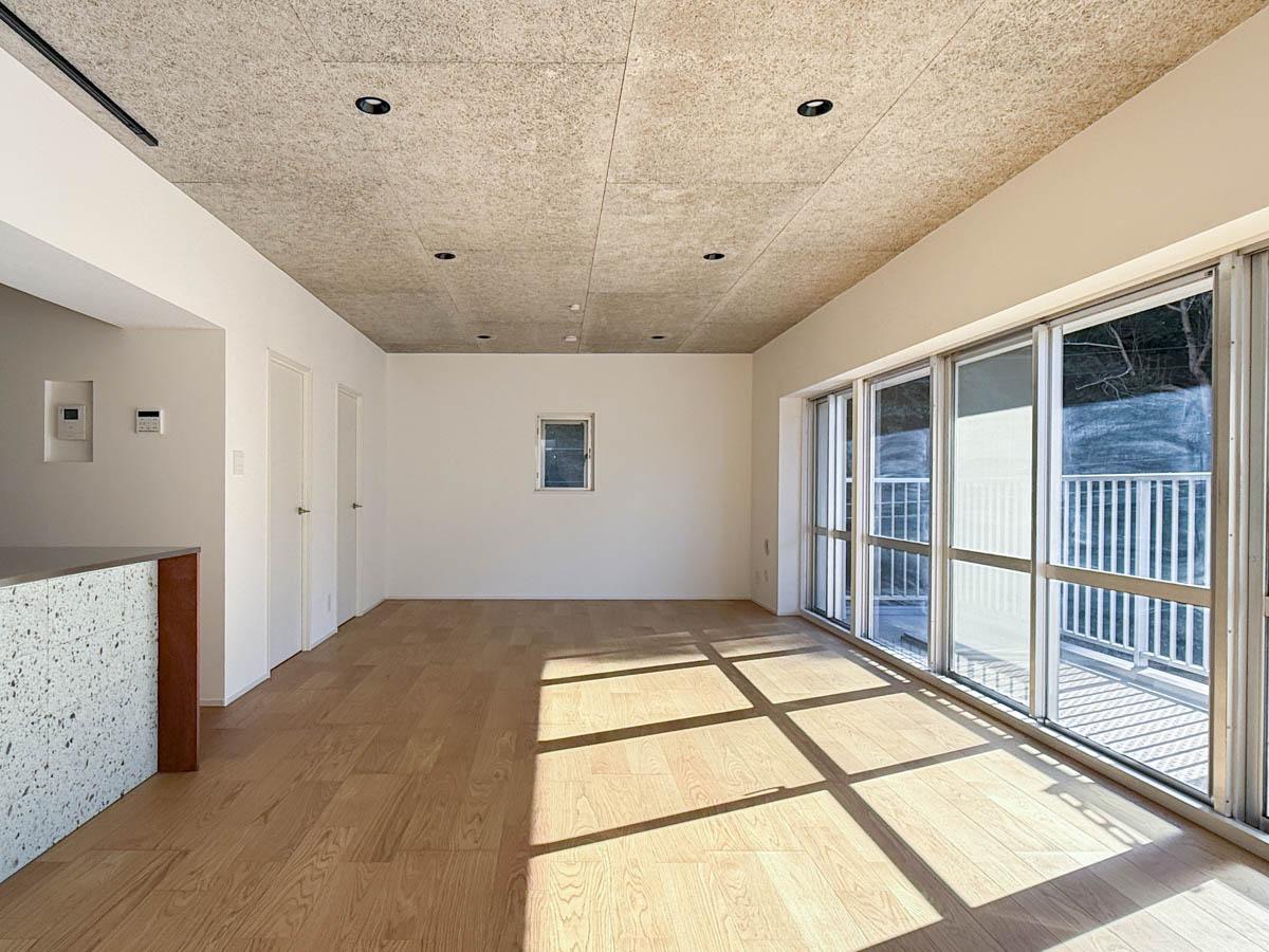 町田市山崎町の売買物件/約23.5帖のLDK。家族が同時に過ごしても余白を感じられる広さ。木毛セメント板の天井がラフで雰囲気がある