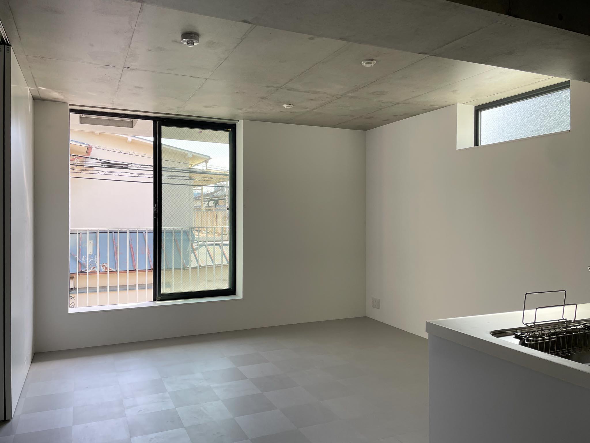 杉並区高円寺南の賃貸物件/203：白いクロスの壁に、天井はつるりとしたコンクリート打ちっぱなし。床にはグレーのフロアタイルを敷き、全体を落ち着いたトーンでまとめています