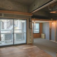 渋谷区神宮前の賃貸物件/ざっくり繋がった開放的な空間を、床や天井の高さ、床の素材などを変えることで緩やかに区切っている