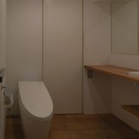 中野区中野の売買物件/洗面所の脇にウォシュレット付きトイレ。奥の引き戸の先が浴室