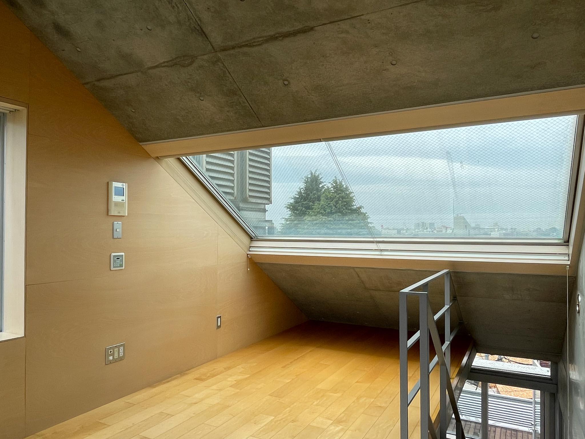 武蔵野市御殿山の賃貸物件/6F：大きな傾斜窓は、下にベッドを置くことを想定して設けられているかのよう