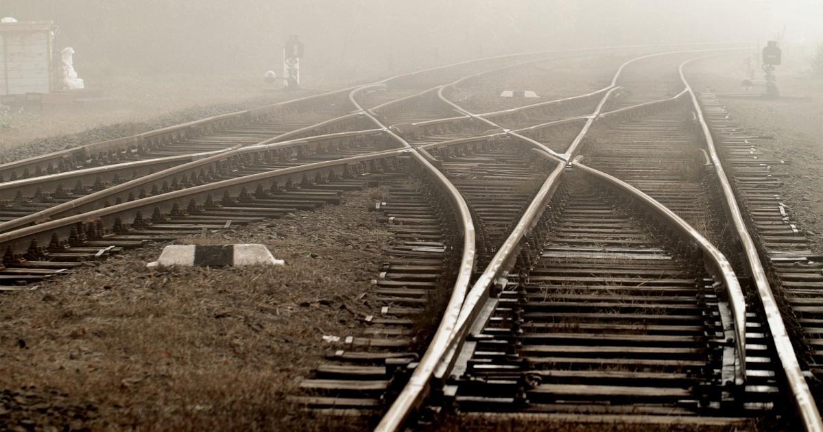 Railway in fog on station, outdoor landscape