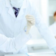 Scientific research team with clear solution in laboratory