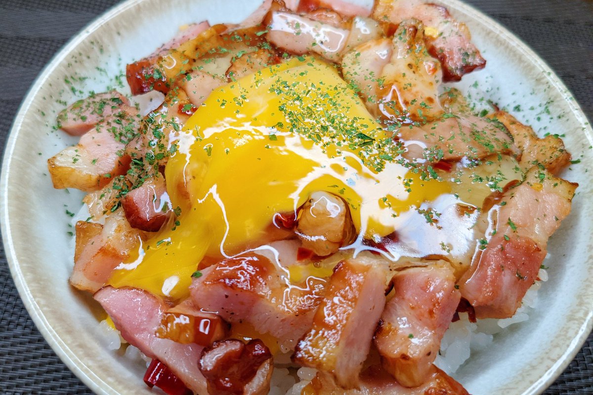 めんつゆペペロン丼】　  ①フライパンにごま油小さじ1を入れ弱火でベーコンとにんにくを炒める ②ベーコンが焼けたらめんつゆ、ブラックペッパー、唐辛子を入れ、軽く炒める ③ごはんの上にのせ卵黄、パセリをのせて完成  にんにくとめんつゆの味が染みたベーコンは超美味です